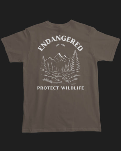 Brown t-shirt with white graphic and text 'Endangered Protect Wildlife' on a white background