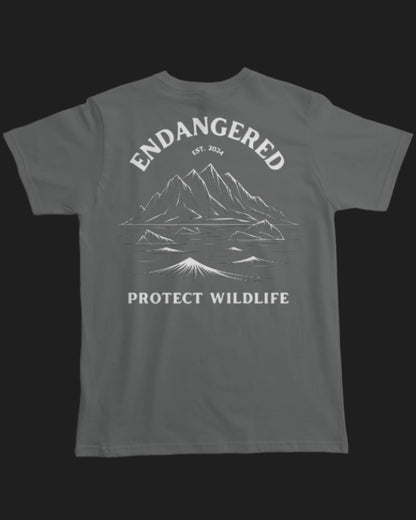 Gray t-shirt with mountain graphic and 'Endangered Protect Wildlife' text on a white background