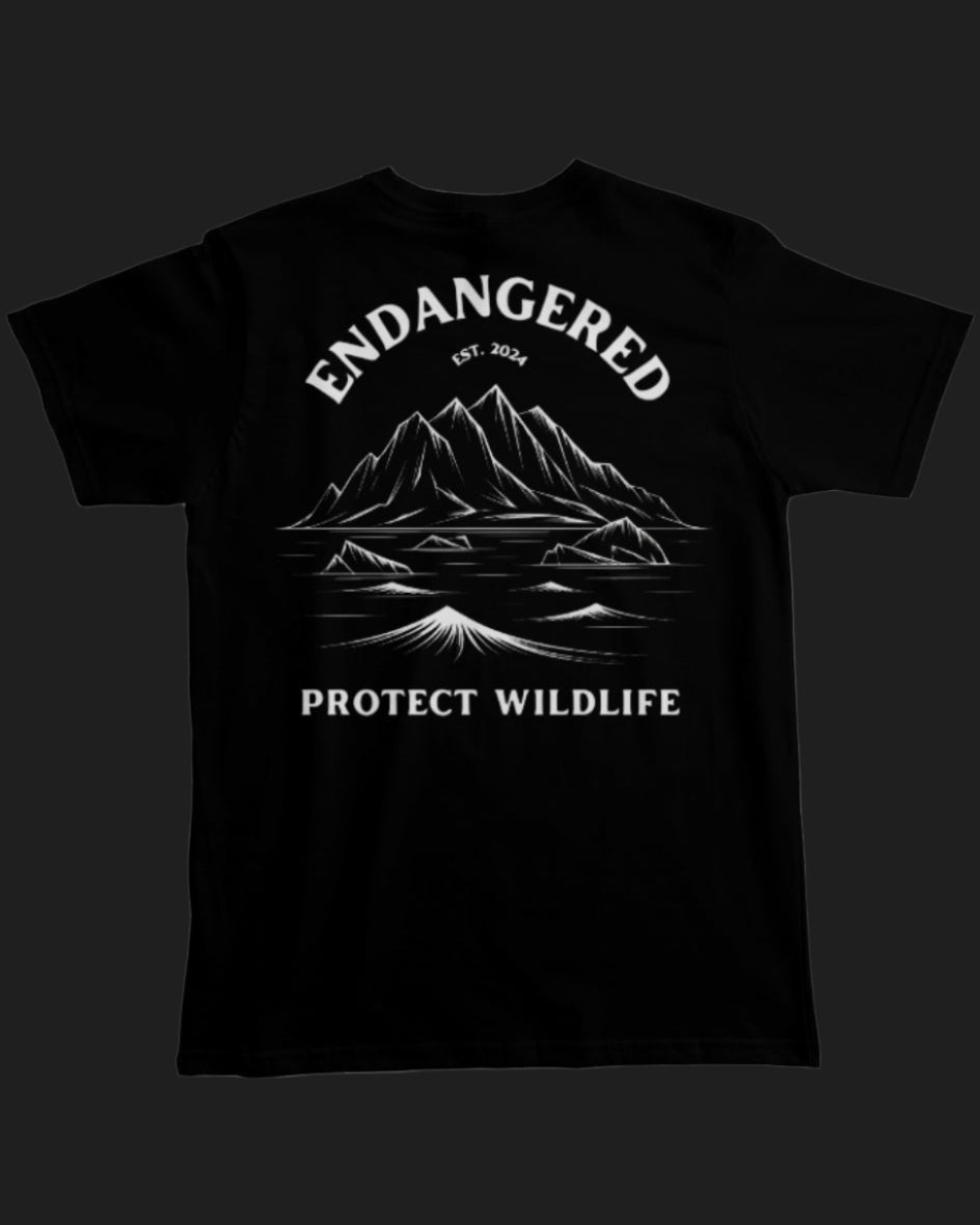 Black t-shirt with mountain graphic and 'Endangered Protect Wildlife' text on a black background